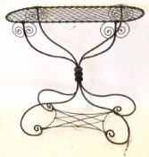 Decorative wire work plant stand of D-ended rectangular form, raised on a scrolled support, 89cm