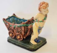 Majolica plant holder modelled as a cherub pulling a cart on rectangular base