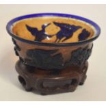 Peking glass blue ground bowl, the exterior decorated in relief with penguins and a floral design,