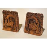 Pair of Chinese wooden carvings mounted on metal bases, the carvings with Chinese figures on