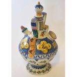 Continental pottery puzzle jug with strap handle, the body with majolica glazes with panels