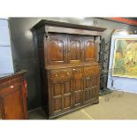 Oak court cupboard, overhanging frieze over three panelled doors, three further frieze drawers and