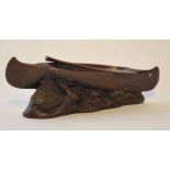 20th century cast and patinated souvenir model in the form of a Native American canoe on a