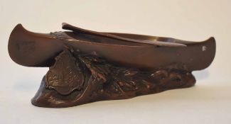 20th century cast and patinated souvenir model in the form of a Native American canoe on a