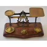 Late 19th century walnut based brass postal scale, the serpentine front fitted with a scale