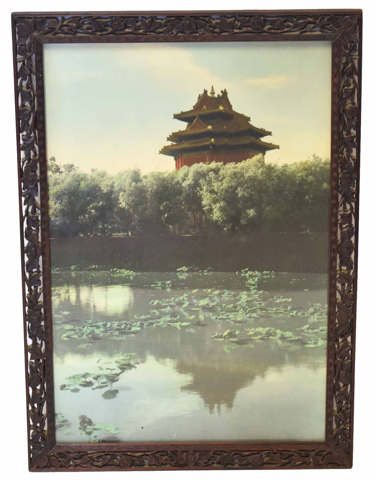 Oriental print of a temple in carved wooden frame