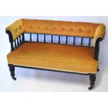 Late Victorian ebonised cottage sofa upholstered in ochre with a button back, 120cm wide