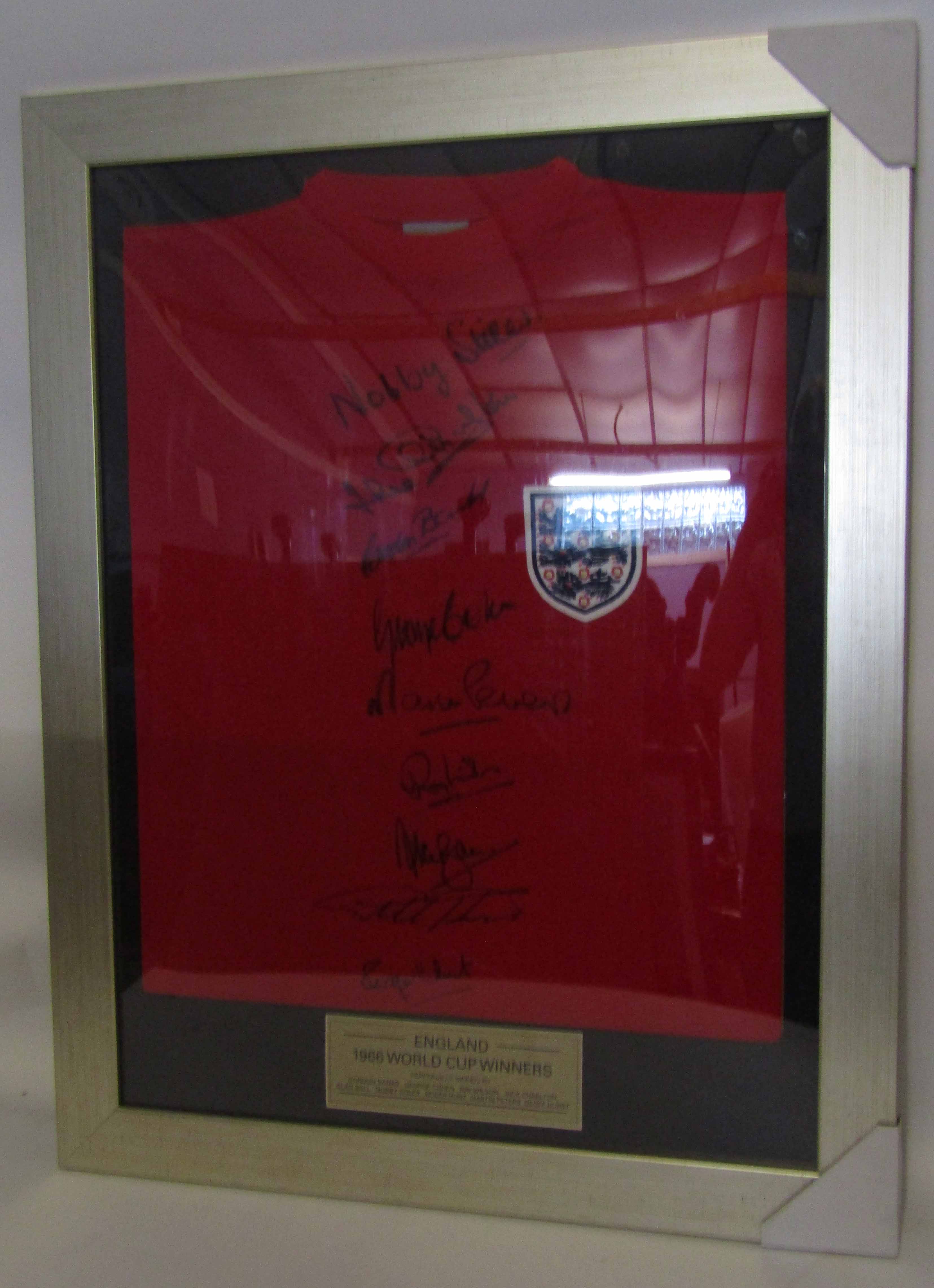 Framed England shirt signed by 1966 World Cup Winners as follows: