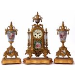 Late 19th century French porcelain and gilt spelter mounted clock garniture, the case surmounted