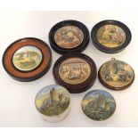 Group of pot lids one with pottery base, the others in wooden frames, decorated in Pratt ware