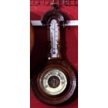 Late 19th century walnut cased aneroid wheel barometer, carved and shaped case set with an opaque