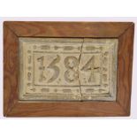 Vintage plaster plaque bearing date 1584 (damaged) in a pine frame, 24cm wide