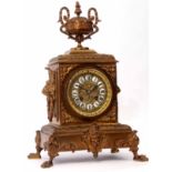 Early 20th century cast brass mantel clock, the plinth shaped case surmounted by two handled and