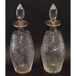 Pair of cut glass decanters with Birmingham silver collars and tear drop stoppers, 29cm high (2)