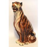 Very large model of a tiger seated on its haunches, 75cm high