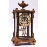 Late 19th/early 20th century American gilt four glass mantel clock, the plinth shaped case