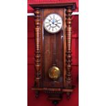 Early 20th century walnut cased Vienna type wall clock with overhanging cornice and baluster