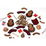 Mixed Lot: various British Red Cross cloth badges, shoulder titles, cap badges, together with a