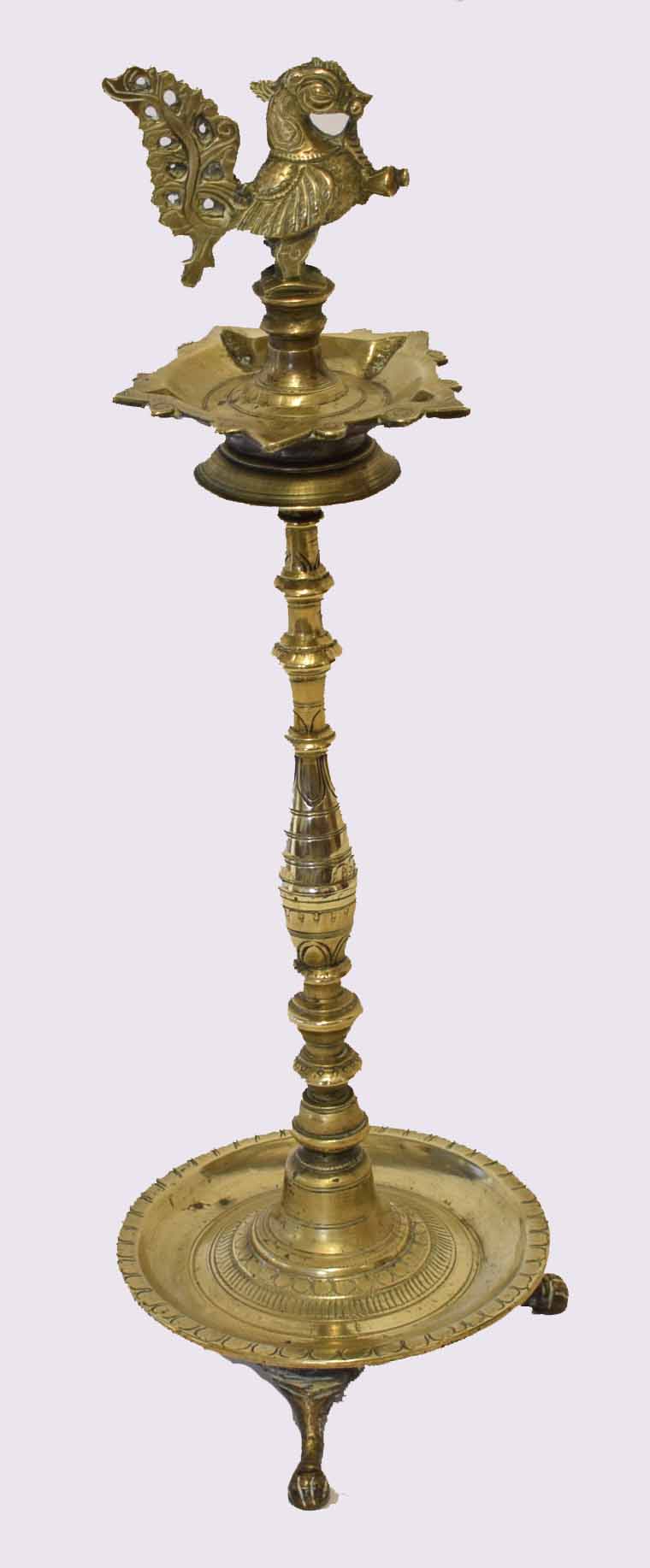 Indian brass table ashtray, crested with temple dog, raised on a twisted stem terminating in a