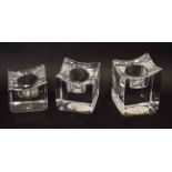 Boxed set of three Orrefors glass candle holders, 10cm high, the holders with etched Orrefors