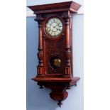 Late 19th century walnut cased Vienna type wall clock with overhanging cornice to half baluster