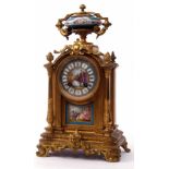 Late 19th century French gilt metal and porcelain mounted mantel clock, the arched case surmounted