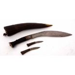 Brass and horn handled Kukri with engraved blade back in a fitted leather covered scabbard with