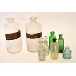 Collection of glass chemist's jars and bottles comprising two large clear glass jars with labels and
