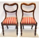 Pair of Victorian rosewood balloon back dining chairs, striped drop in seats with ring turned