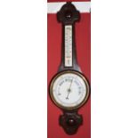 Early 20th century carved oak aneroid barometer with twin scale porcelain backed mercury thermometer