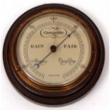 Early 20th century oak mounted aneroid barometer with ring turned surround to a spun brass bezel