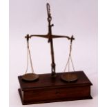 Late 19th century oak cased beam scale, the rectangular base fitted with single drawer containing