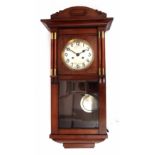 Mid-20th century stained beech wall clock with overhanging cornice and shaped pediment over brass