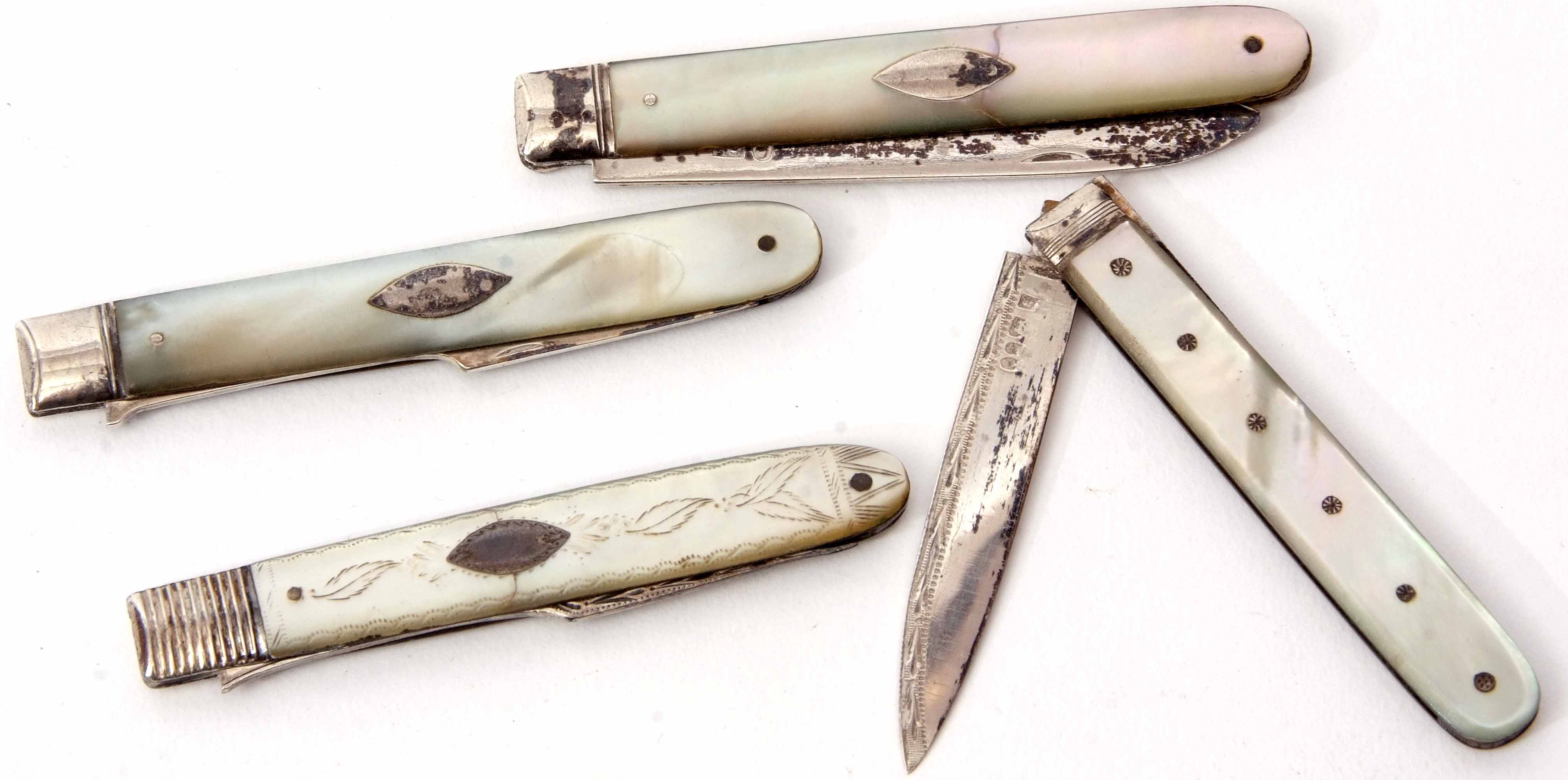 Mixed Lot: comprising two hallmarked silver folding fruit forks, together with two folding fruit