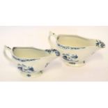 Pair of Lowestoft sauce boats, the bodies moulded with flowerheads with fishing scenes to front