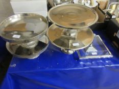 FOUR CIRCULAR CHROMIUM CAKE STANDS TOGETHER WITH A GLASS FRAMED CAKE STAND (5)