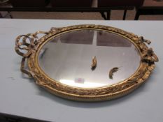 GILT OVAL FRAMED WALL MIRROR WITH RIBBON TOP