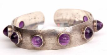 Mid-20th century silvered dog collar style bangle studded with eight quality cabochon amethyst