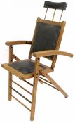 20th century reclining chair with head rest, padded leather seat, bearing worn manufacturer's label