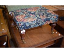 MAHOGANY FRAMED SQUAT STOOL WITH TURNED LEGS AND BRASS CASTERS WITH FLORAL UPHOLSTERED TOP