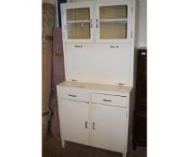 WHITE PAINTED KITCHEN CUPBOARD WITH DROP FRONT WITH ENAMEL TOP, FITTED WITH TWO GLAZED DOORS AND TWO