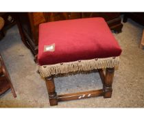 OAK FRAMED RECTANGULAR RED DRALON UPHOLSTERED FOOT STOOL WITH GOLD TASSEL DETAIL