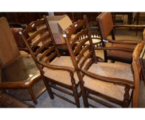 PAIR OF OAK FRAMED LADDERBACK ARMCHAIRS WITH RUSH SEATS