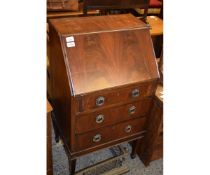 EDWARDIAN MAHOGANY SMALL PROPORTIONED BUREAU WITH THREE DRAWERS WITH RINGLET HANDLES ON TAPERING