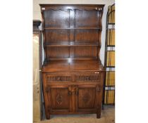 OAK FRAMED DRESSER, THE TOP FITTED WITH TWO FIXED SHELVES, THE BASE WITH TWO DRAWERS OVER TWO