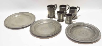 Three 19th century pewter chargers, largest 42cm diam, some with London touch marks, together with