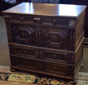 Early 18th century oak chest of four graduated drawers, all with geometric dummy fronts, raised on