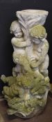 Weathered composition garden pedestal formed as putti clutching a flowering plant, 92cm high