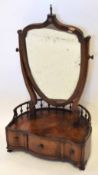 18th century and later walnut toilet mirror, shield shaped mirror panel crested with an urn over a