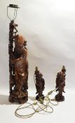 Large Chinese hardwood carved model of an immortal on carved scroll base converted to a lamp,